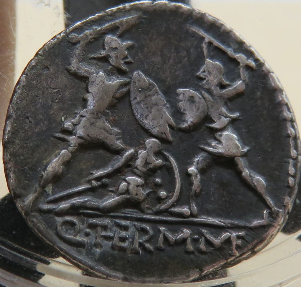 Reverso de moeda da República Romana com soldados enfrentando inimigo.